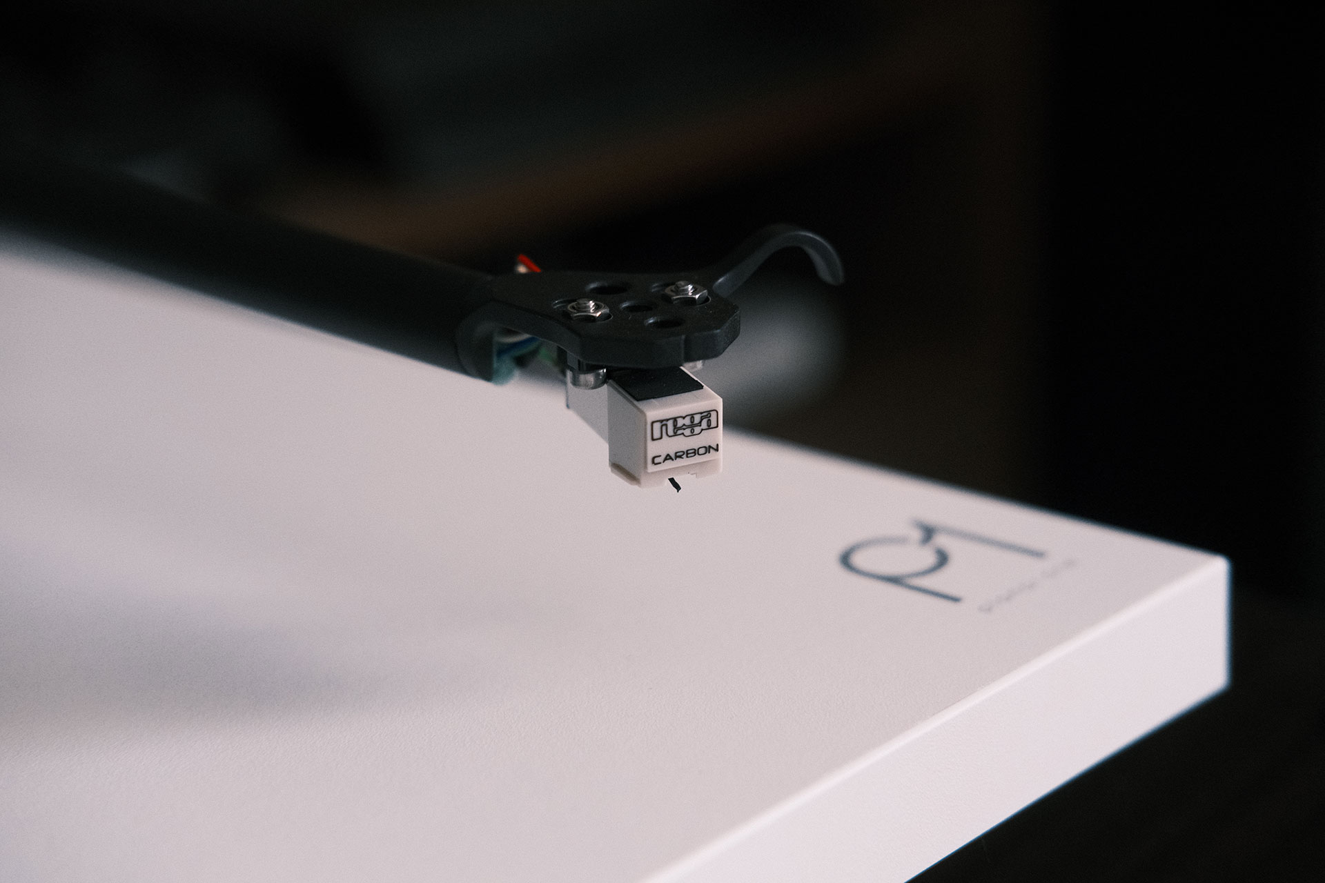 Detailed view of the Rega Planar 1 tonearm and cartridge highlighting precision engineering