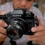 A man holding a Fujifilm X-T2 camera