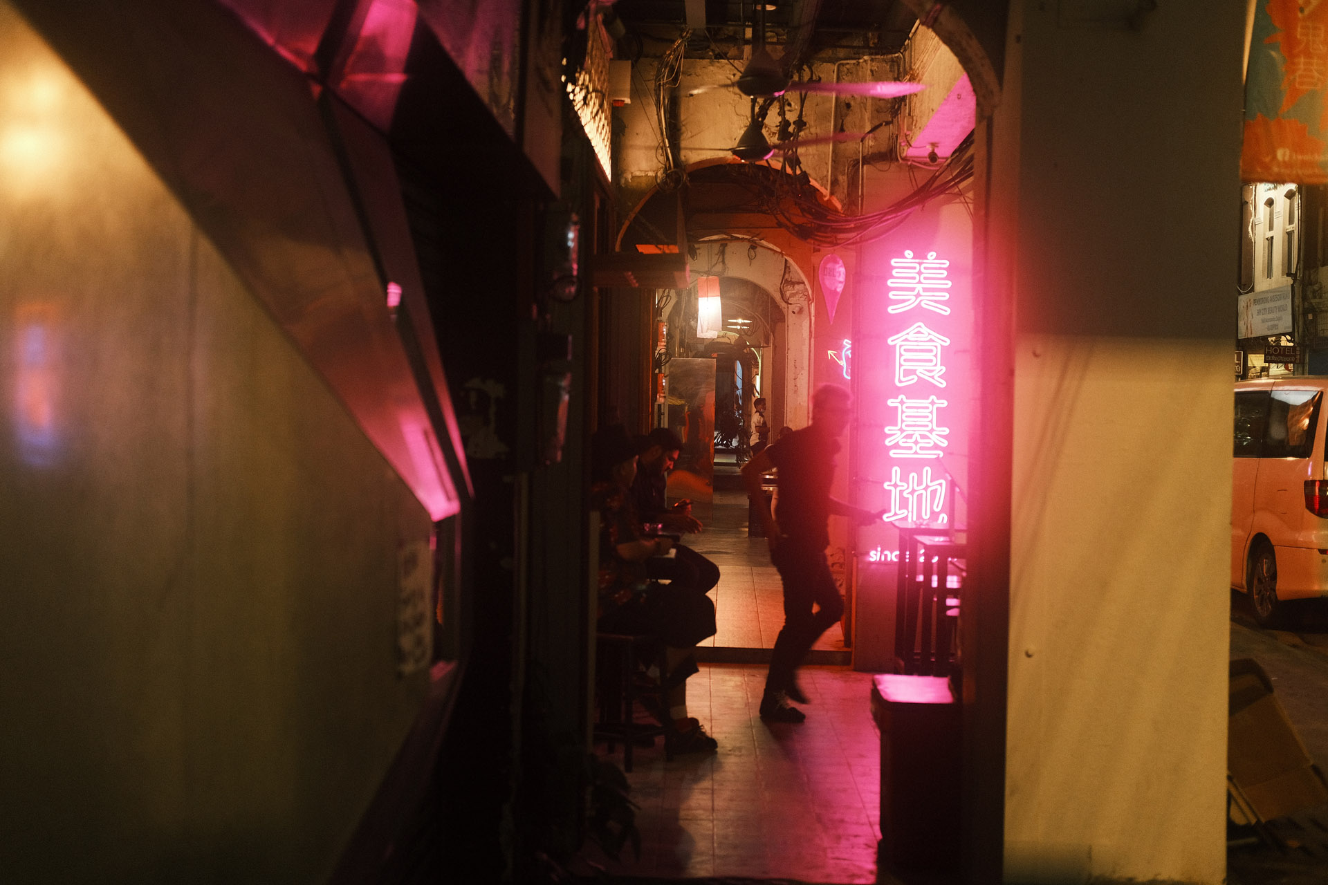 A man walking pass Neon light in Petaling Street at night - Metropolis 500T Classic Negative Film Simulation recipe