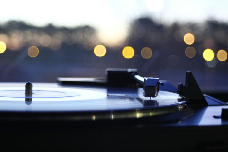 Boost Your Record Player Sound Quality - Turntable with city light in the background