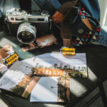 How to shoot film photography beginner tips - Film camera, film rolls and photos on the table